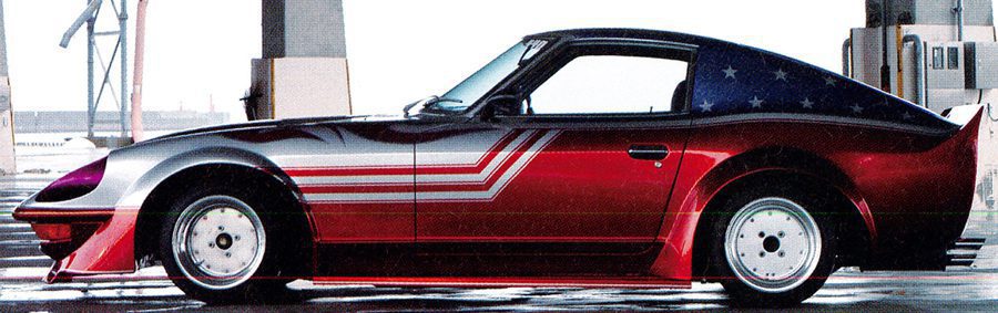 Vintage sports car with a red, white, and blue paint job parked in an industrial area.