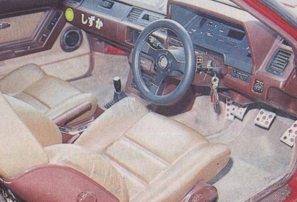 Vintage car interior with leather seats, classic steering wheel, manual transmission, and Japanese emblem reading Quiet.