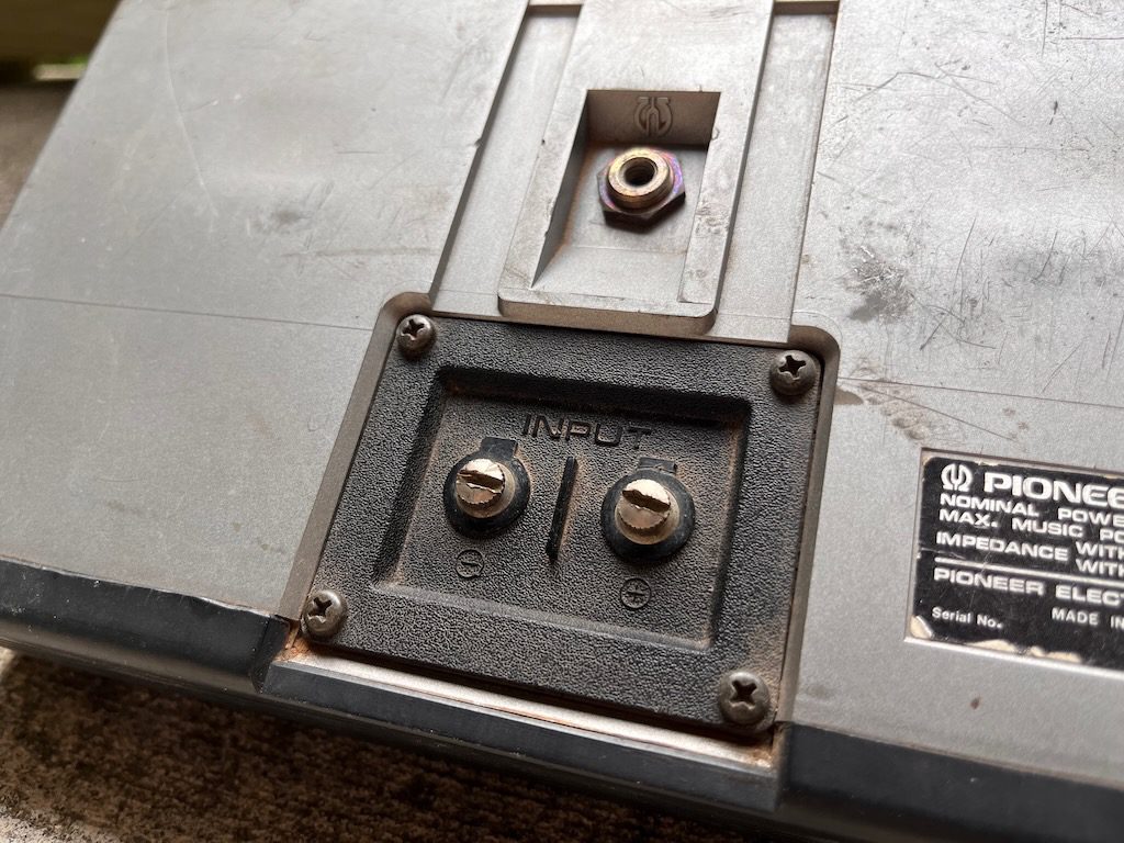 Close-up of Pioneer electric device input connections and label, showing Made in Japan and specifications in English.