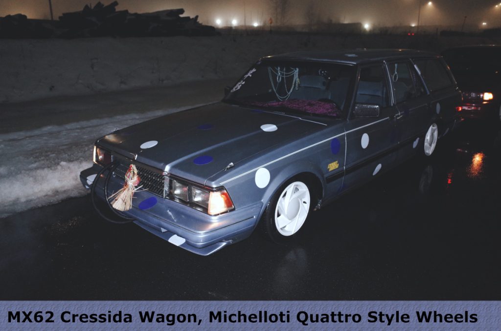 Modified MX62 Cressida Wagon with Michelotti Quattro style wheels and Japanese decor in night setting.