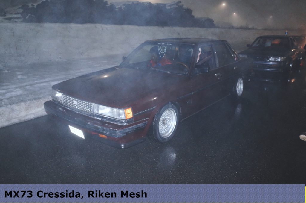 Classic MX73 Toyota Cressida with Riken Mesh wheels parked on a foggy night.