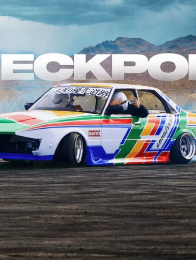 Colorful drift car with driver in helmet sliding on track, CHECKPOINT text in background.