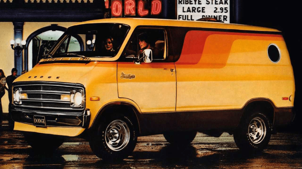 Vintage Dodge van with distinctive 70s design parked on a city street at night, showcasing its retro style and colors.