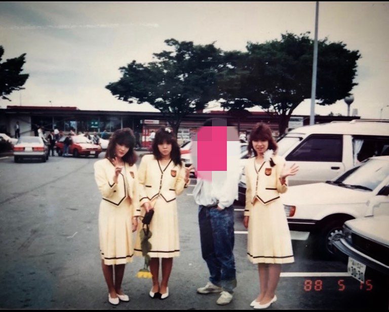 Group posing in a parking lot, three women in matching pale yellow outfits, one person with a pixelated face. Dated May 15, 1988.
