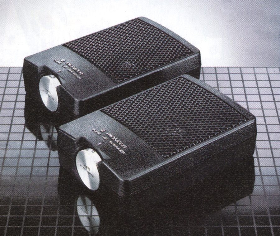Alt text: Two black Pioneer Hi-Fi amplifiers on a grid-patterned surface, showcasing sleek design and modern technology.