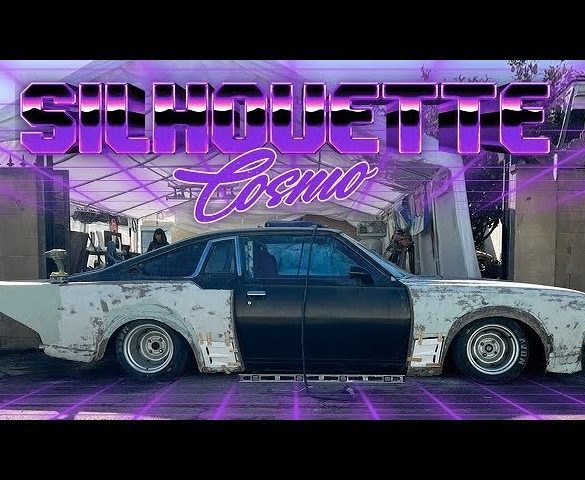 Modified classic car under a canopy with neon text Silhouette Cosmo above, highlighting custom automotive restoration.