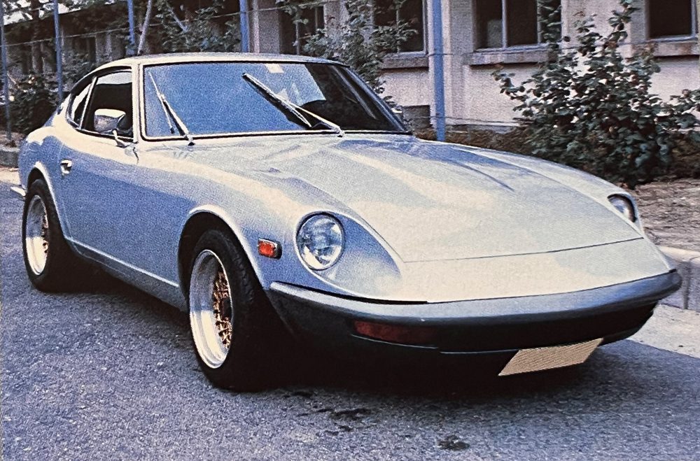 Vintage Datsun 240Z sports car with classic design and sleek lines, parked on a residential street.