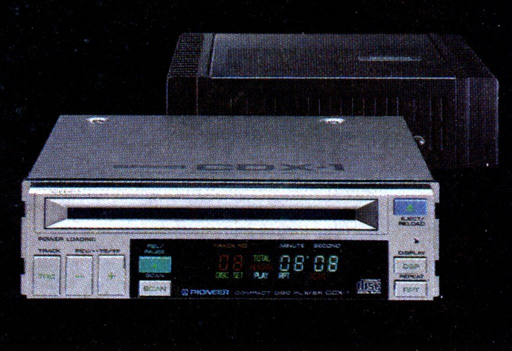 Front view of Pioneer PD-X1 Compact Disc Player, showing display, play controls, and loading slot against a dark background.
