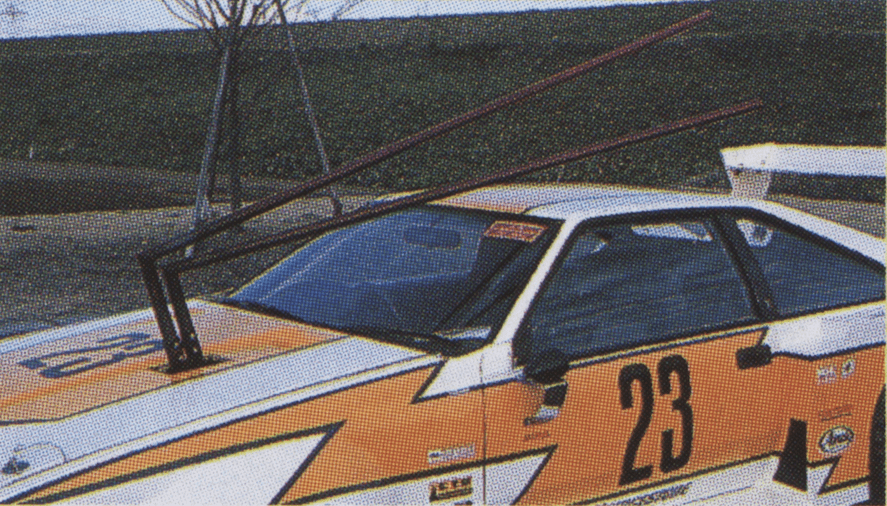 Unique racing car with number 23 and custom roof exhaust pipes, showcasing creative automotive modifications.